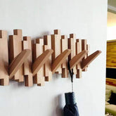 Wooden Coat Rack with Foldable Hooks that can be mounted on the wall for decorative clothes hanging purposes.